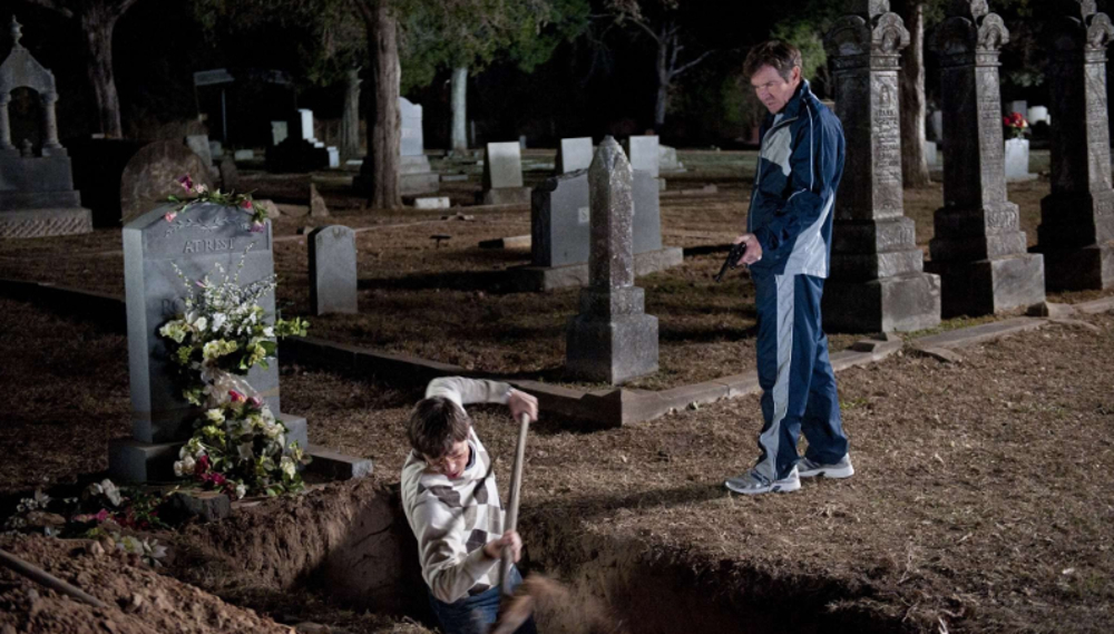 Dennis Quaid and Tony Oller in a graveyard in Beneath the Darkness