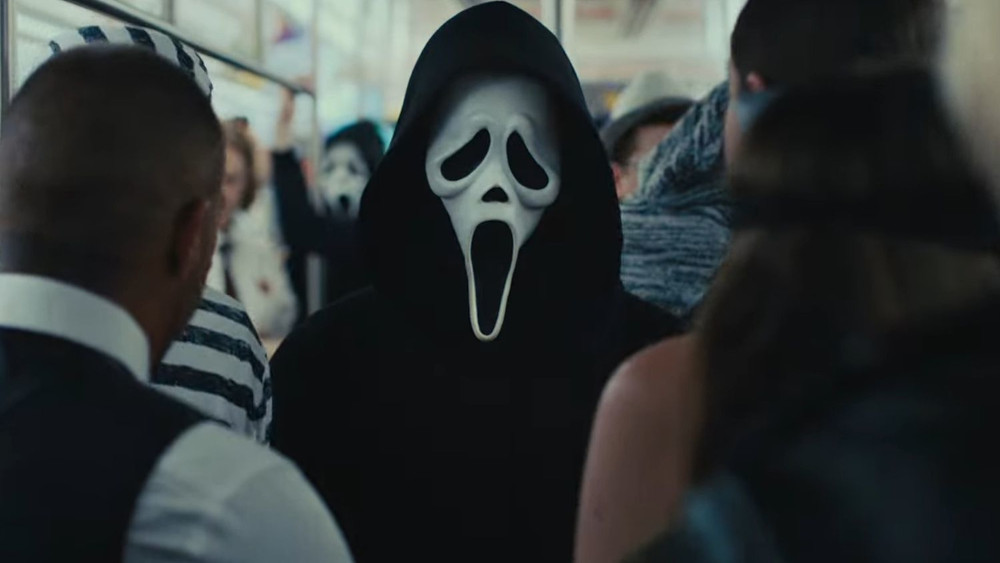Ghostface making his way through the crowded train in Scream 6.