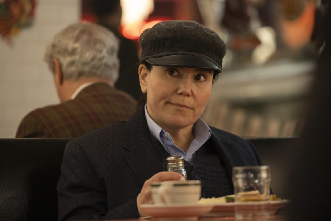 Susie sits in a diner while looking pensive in The Marvelous Mrs. Maisel Season 5 Episode 5, "The Pirate Queen."