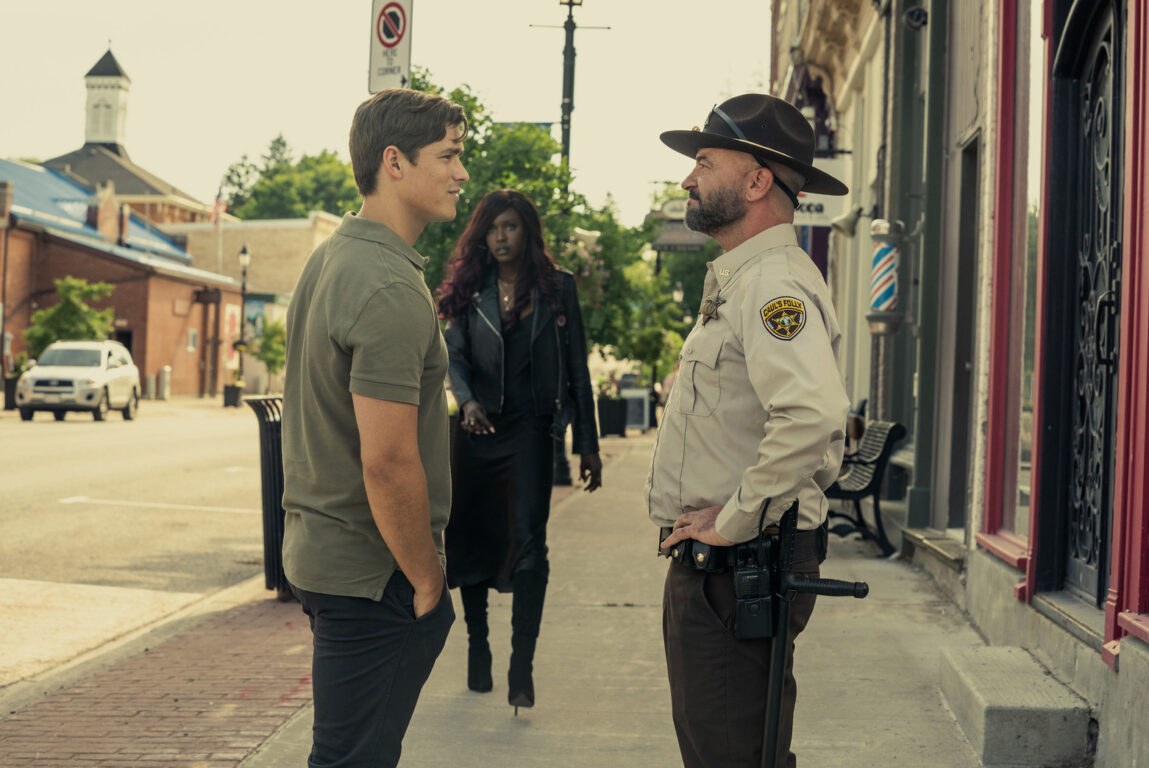 The Sheriff talking to Dick as Kory walks up