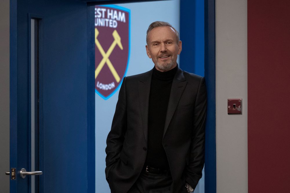 Rupert Mannion stands in the doorway of West Ham United headquarters with his hands in his pockets in Ted Lasso Season 3 Episode 4, "Big Week."