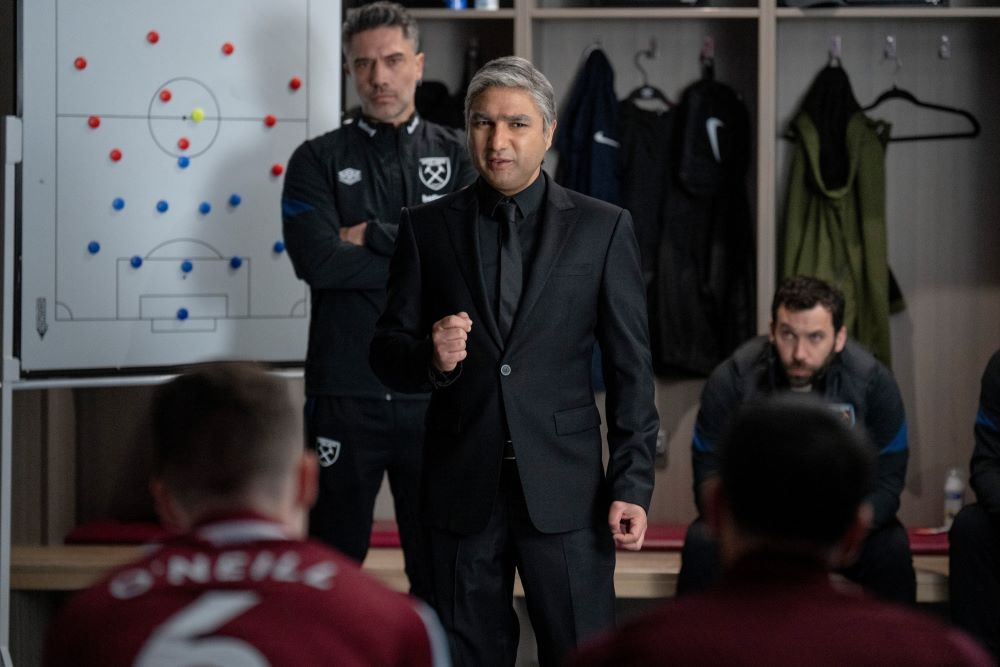 Nate stands in front of a dry-erase board in the locker room at West Ham United while talking to his players in Ted Lasso Season 3 Episode 4, "Big Week."