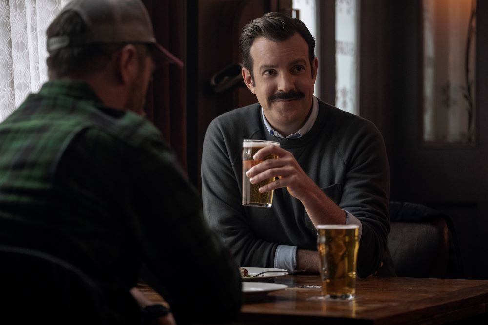 Beard and Ted sit in The Crown & Anchor Pub in Ted Lasso Season 3 Episode 7, "The Strings That Bind Us."