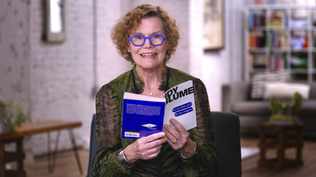 Judy Blume poses with one of her books in Judy Blume Forever.