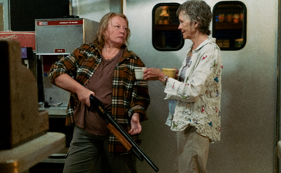 Donna (Elizabeth Saunder) holds a shotgun and Tillie (Deborah Grover) offers a drink in From. 