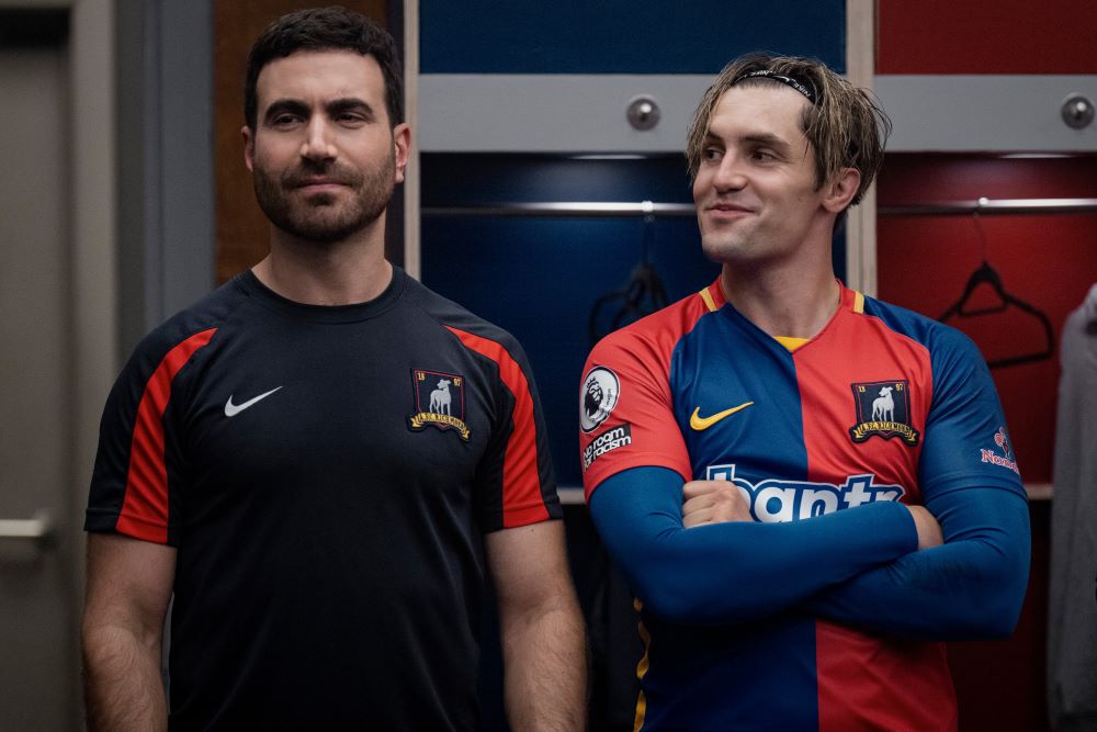 Roy and Jamie stand in the Richmond locker room while Jamie looks at Roy and smiles in Ted Lasso Season 3 Episode 10, "International Break."