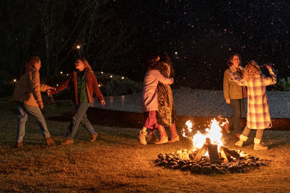 Taissa, Van, Lottie, Natalie, Shauna and Misty dance around a fire outside in Yellowjackets Season 2 Episode 7, "Burial."