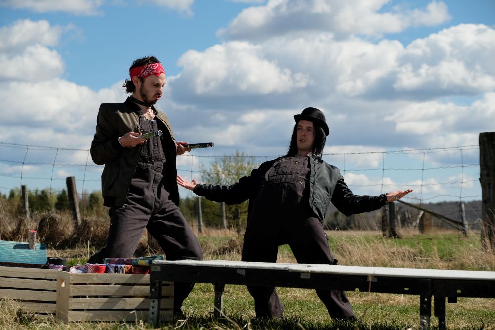 Roald and Stewart play with fireworks while standing in the field outside Wayne and Katy's house in Letterkenny Season 11 Episode 7, "May 2-4."