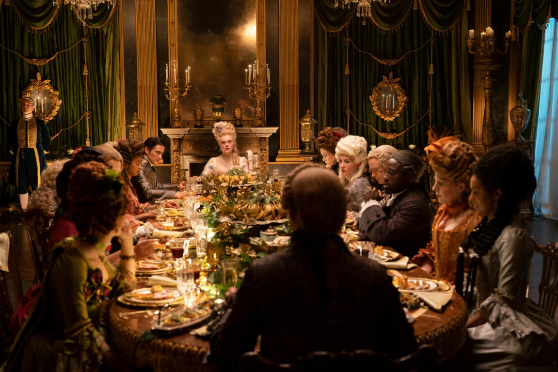 Catherine and Peter host a dinner with the cast sitting at an elaborate dining room table in The Great Season 3 Episode 2, "Choose Your Weapon."