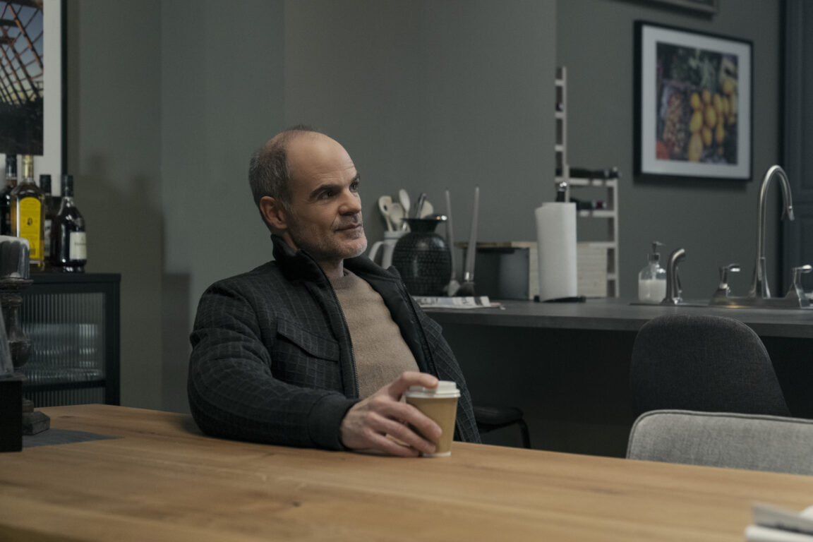 Mike November (Michael Kelly) sits at a table with coffee in Tom Clancy's Jack Ryan