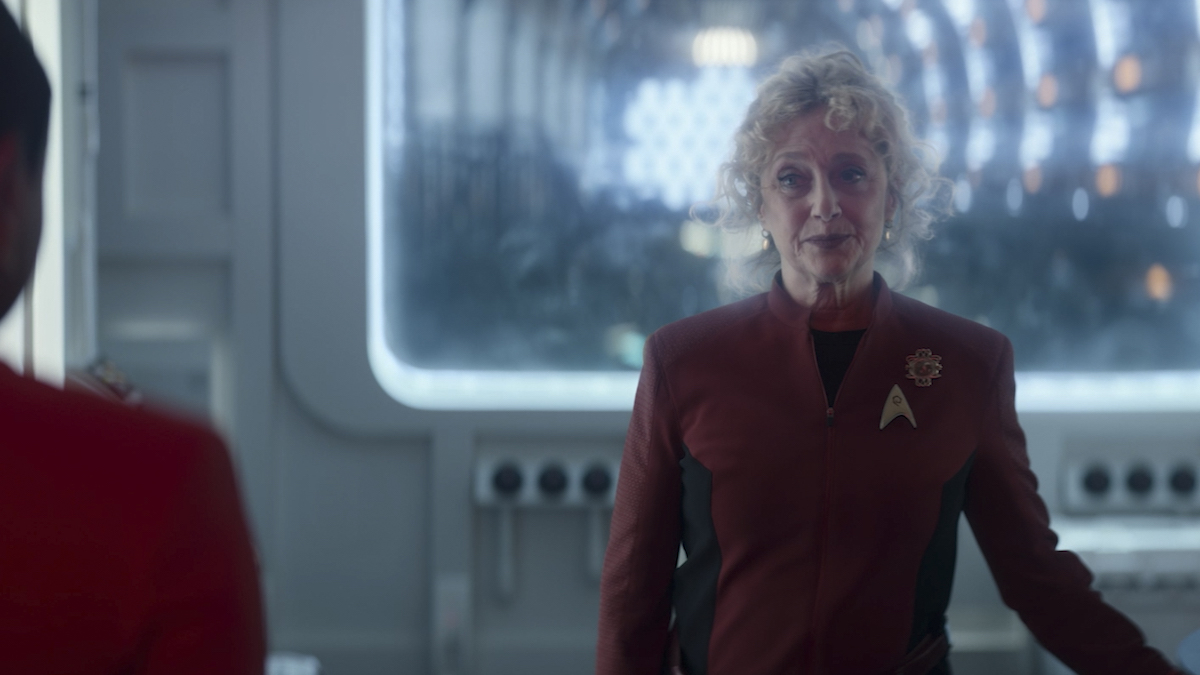 Pelia stands in the nacelle while wearing her red Starfleet uniform and looking attentive in Star Trek: Strange New Worlds Season 2 Episode 6, "Lost in Translation."