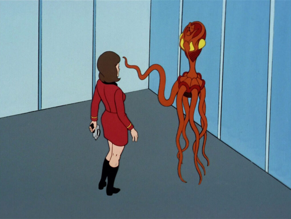 A shapeshifting Vendorian spy extends a tentacle towards an Enterprise crew member.
