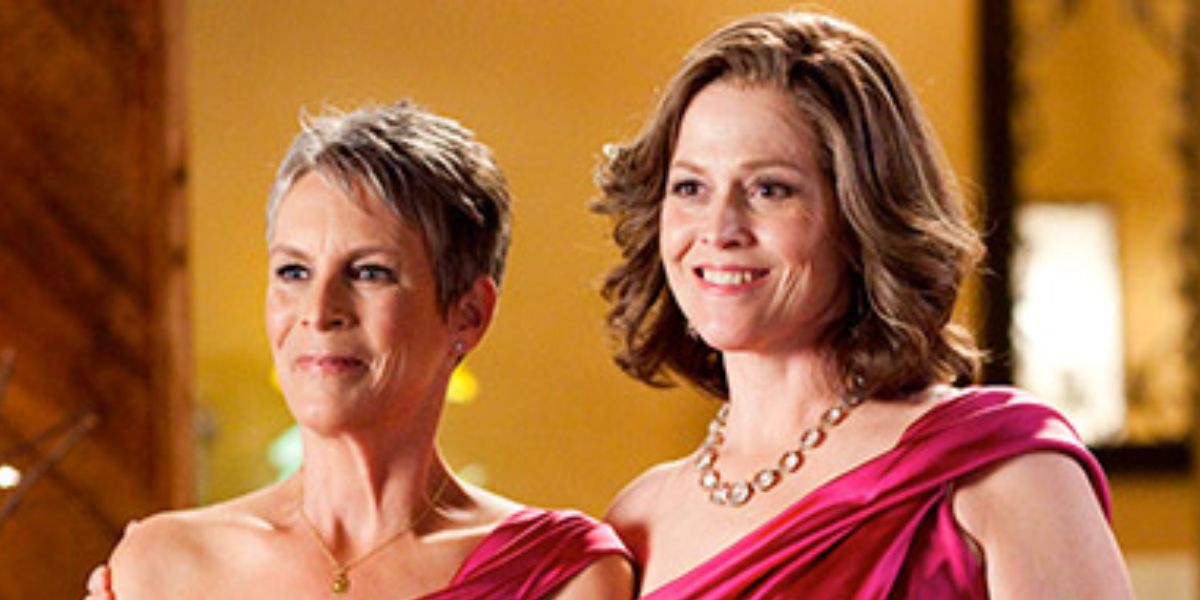 Sigourney Weaver and Jamie Lee Curtis smiling in pink dresses.