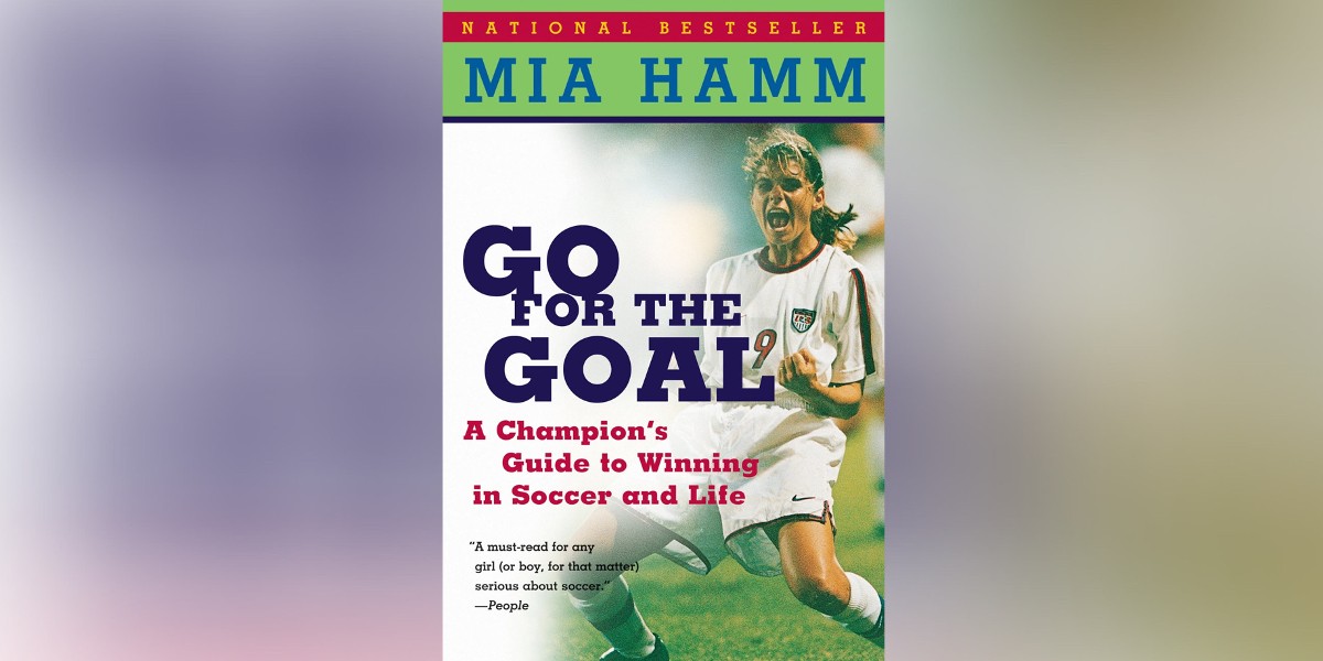 The Cover of Go For the Goal: A Champion's Guide to Winning in Success and Life. Mia Hamm is on the cover celebrating in her USWNT uniform. The words "a national bestseller" run across the top of the cover.