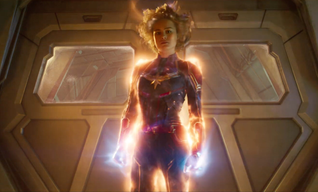 Brie Larson as Carol Danvers in Captain Marvel. She is glowing with energy.