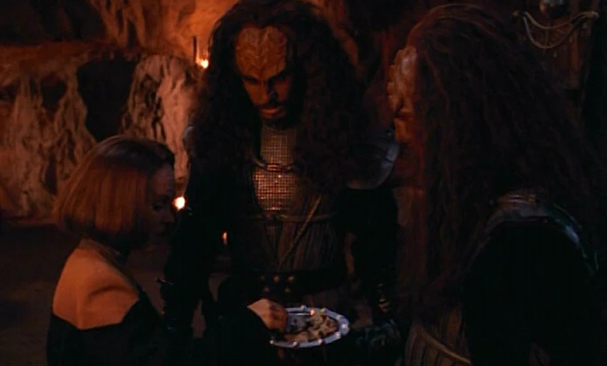 B'Elanna Torres stands with two Klingons in a cave in Star Trek: Voyager.