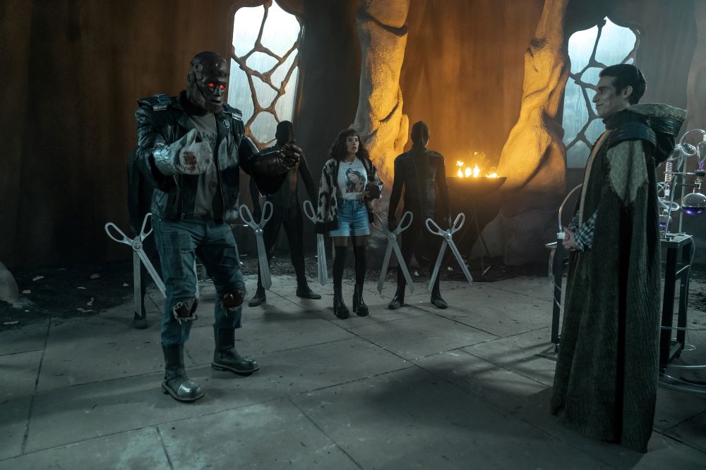 Jane watches in horror while Cliff undergoes a transformation as Wally looks on in approval in Doom Patrol Season 4 Episode 7, "Orqwith Patrol."