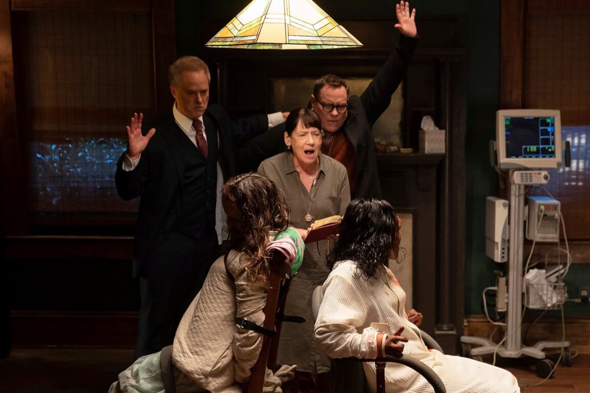 Pastor (Raphael Sbarge), Ann (Ann Dowd) and Stuart (Danny McCarthy) perform an exorcism on Angela (Lidya Jewett) and Katherine (Olivia O'Neill) in The Exorcist: Believer