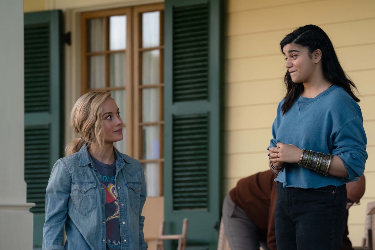 Carol “Captain Marvel” Danvers (Brie Larson) and Kamala “Ms. Marvel” Khan (Iman Vellani) on the porch of the Rambeau house in Lousiana.