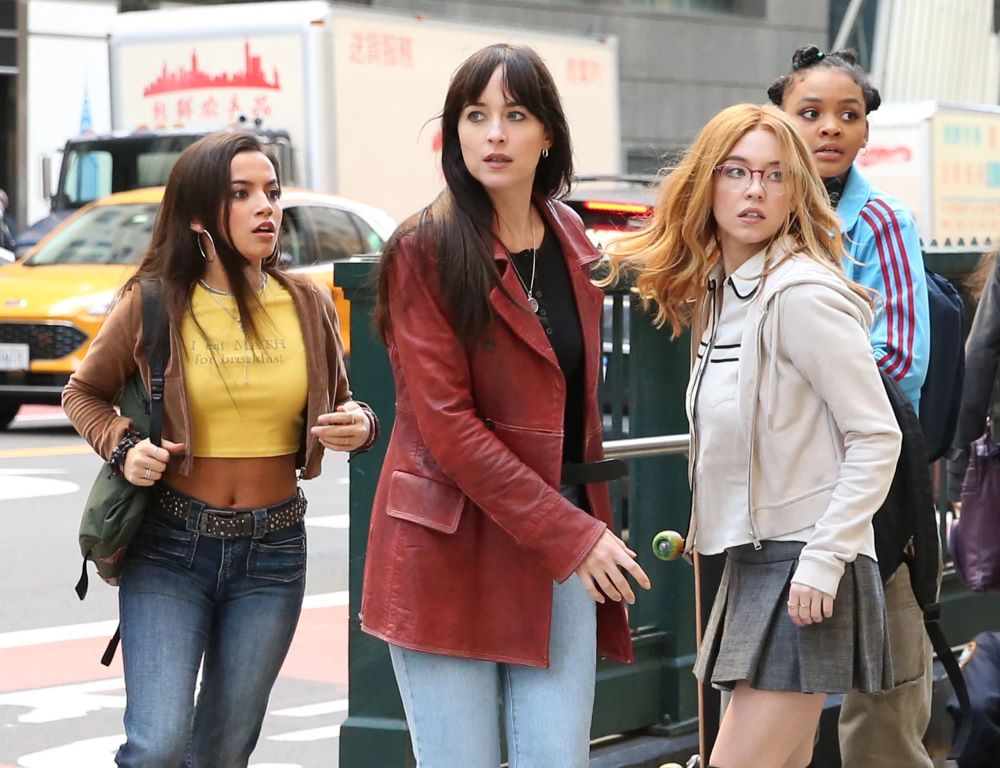 Anya Corazon, Cassandra Webb, Julia Carpenter and Mattie Franklin stand outside a subway station during the day in New York City while looking panicked in Sony's Marvel live-action film Madame Web.