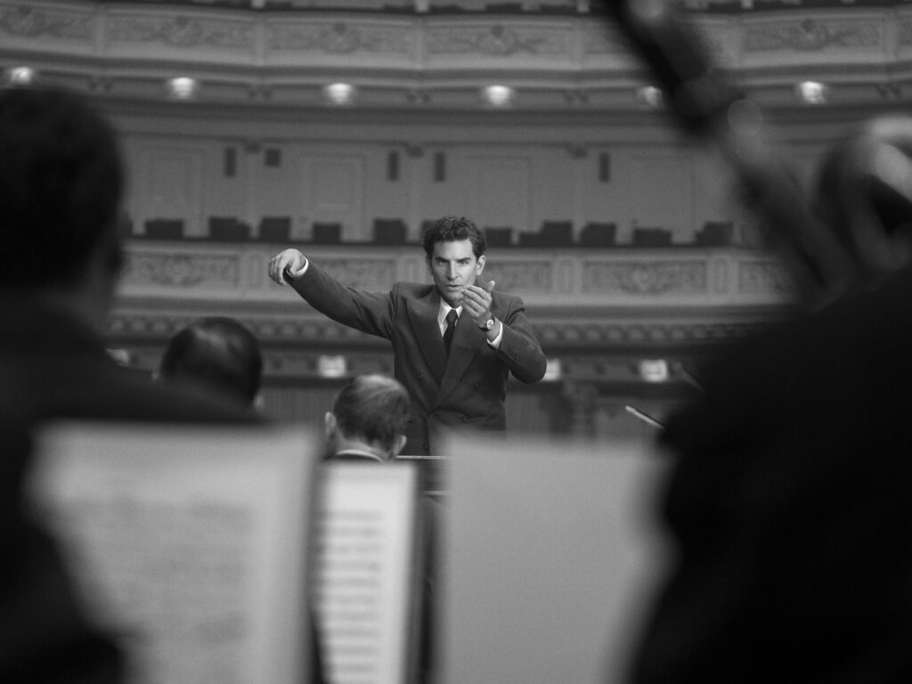 a man conducts an orchestra in the movie Maestro. 