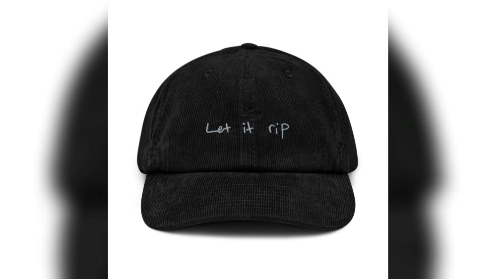 A black corduroy hat inspired by the TV series The Bear with "Let it rip" in white text on the front. 