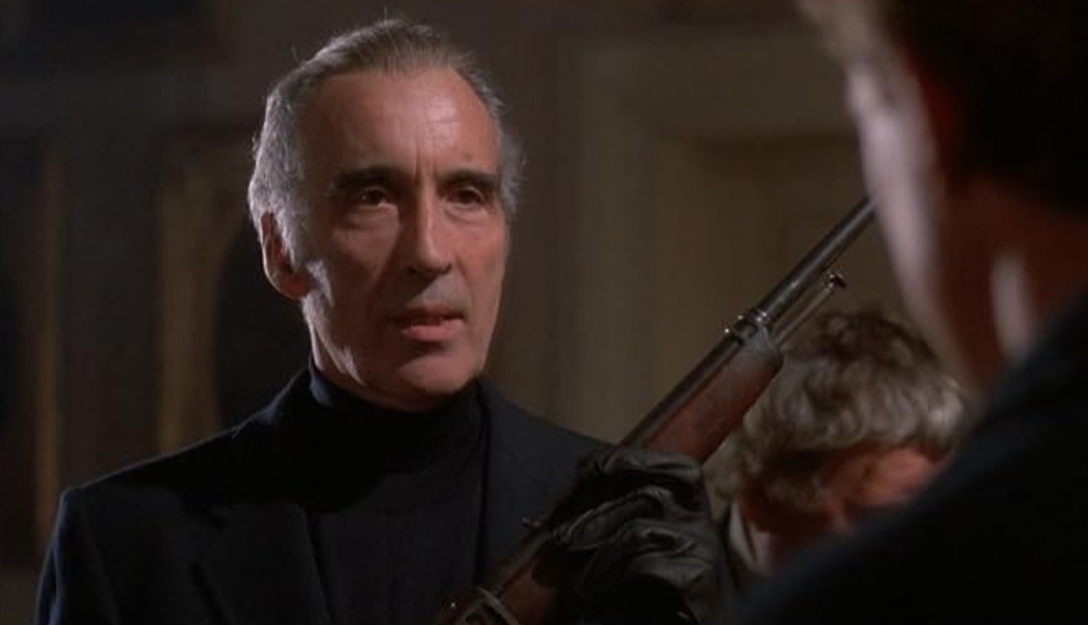 Christopher Lee holds a firearm in the movie Howling II: Your Sister is a Werewolf. 