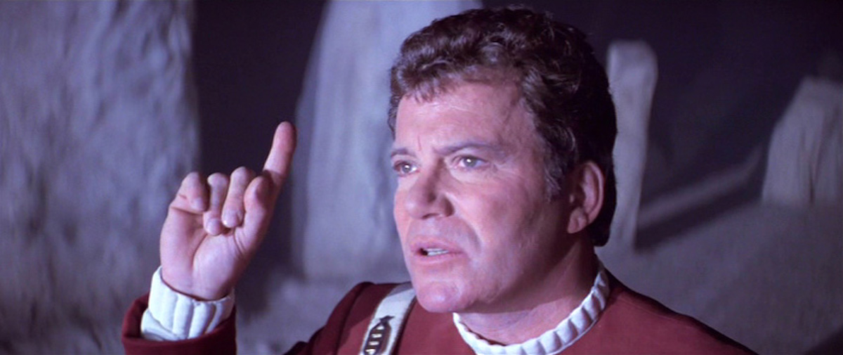 Kirk (William Shatner) raises a finger to god in Star Trek V: The Final Frontier.