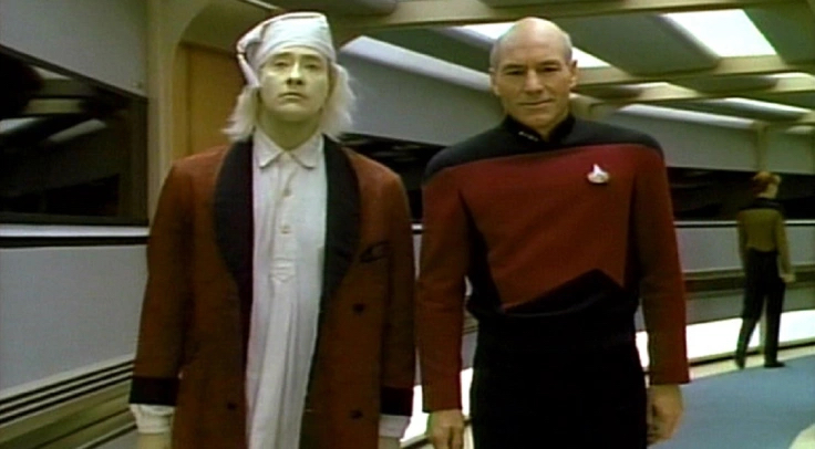 Data (Brent Spiner) as Scrooge, walking beside Jean-Luc Picard (Patrick Stewart) through the hallways of the Enterprise-D on TNG.