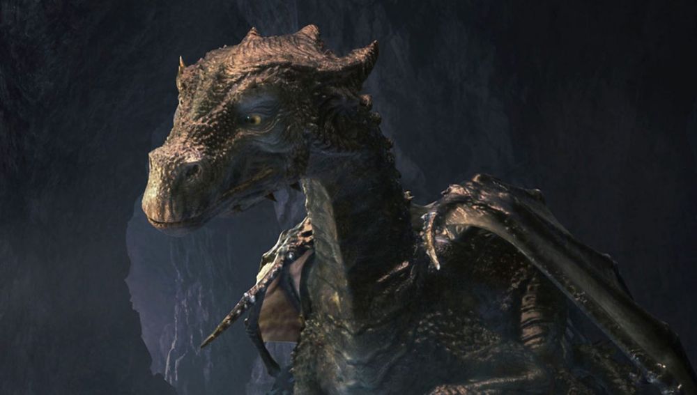Closeup of head of a black scaled dragon, Kilgharrah, in a dark cave in Merlin.  