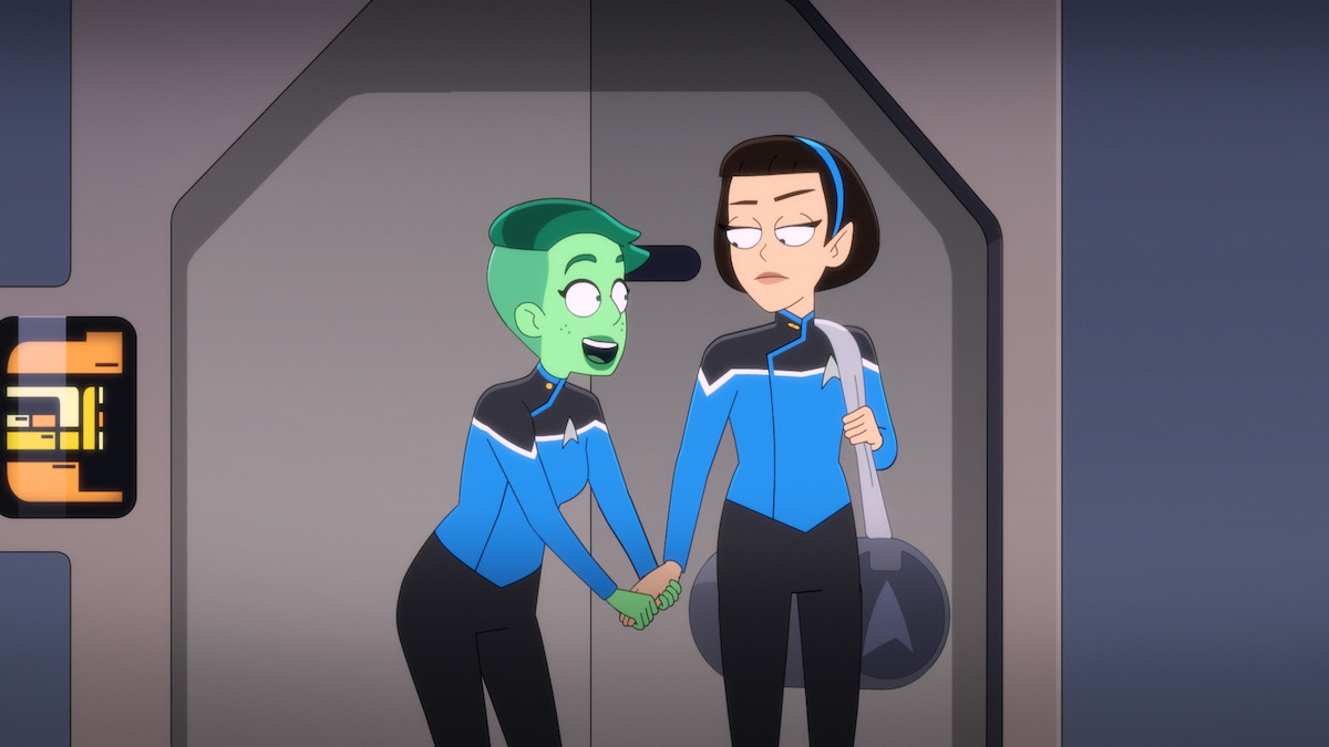 Noel Wells as Ensign Tendi in the Paramount+ series STAR TREK: LOWER DECKS. Tendi is excitedly grabbing T'Lyn's hand.