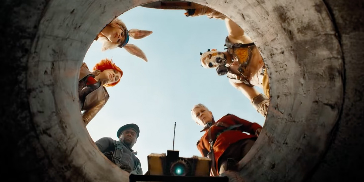The crew from the Borderlands movie all looking downwards into a hole.