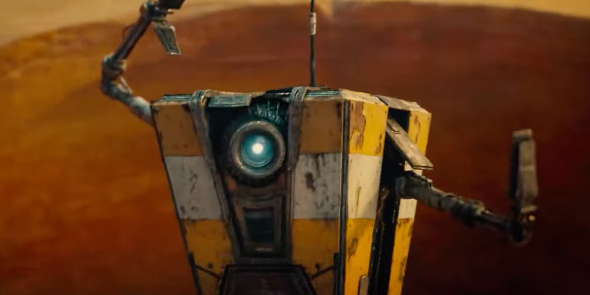 An orange and white robot named Claptrap. It has one circle on its front for an eye.
