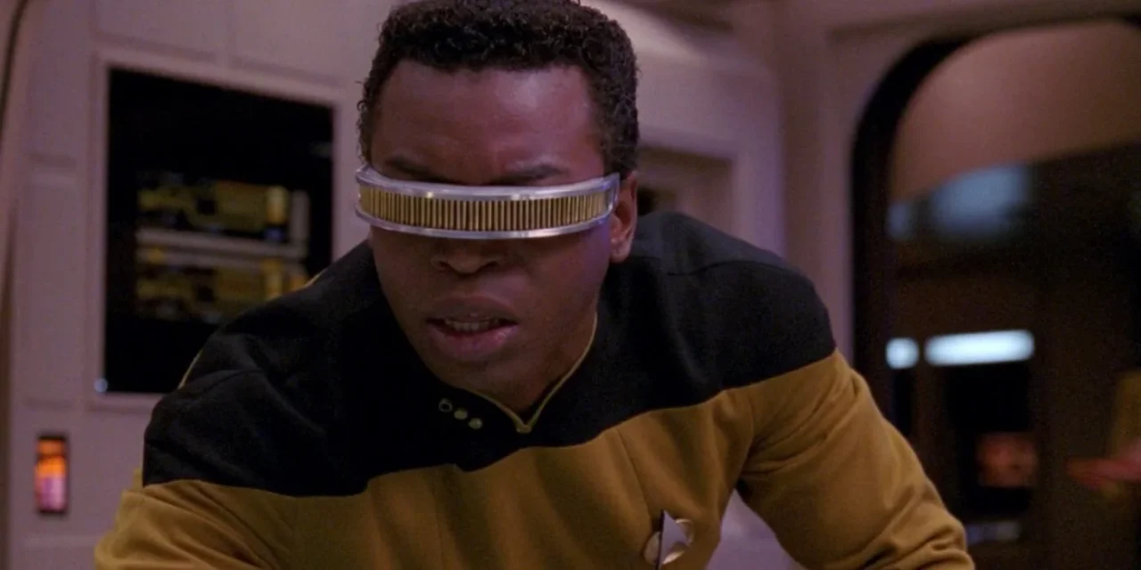 geordi la forge looks aside with an intense face. 