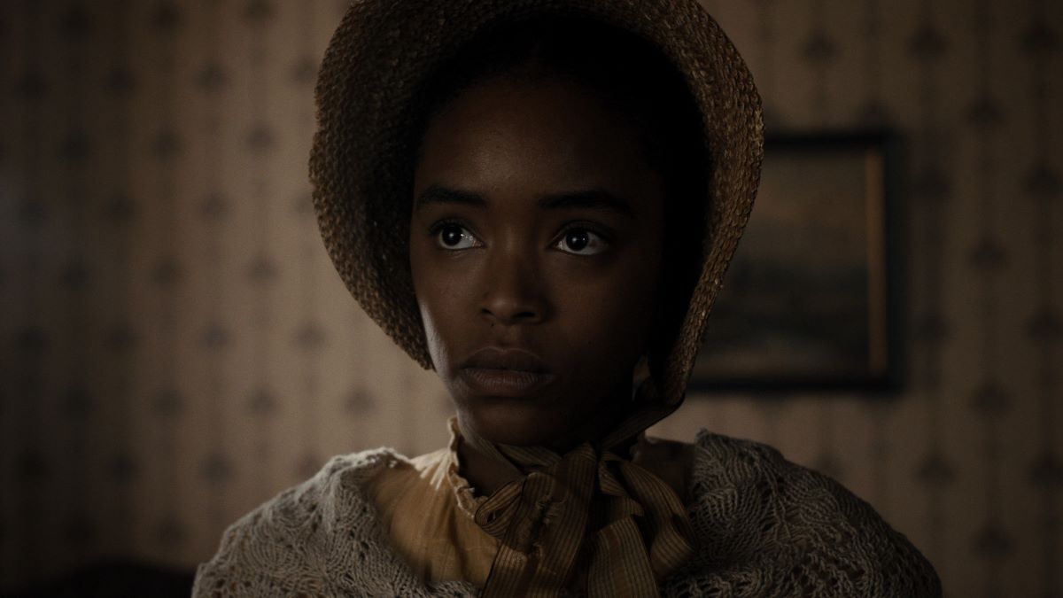 Mary Simms wears a straw bonnet, gray knitted shawl and a tan cotton dress in Manhunt Season 1 Episode 5, "A Man of Destiny."