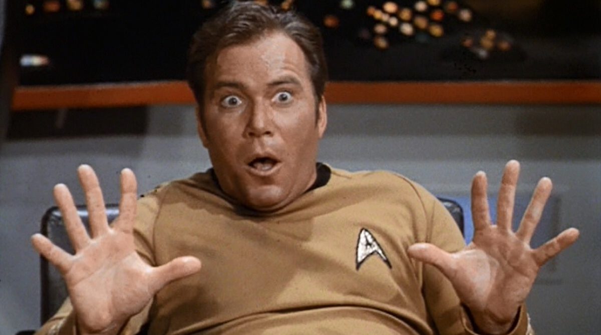 Kirk looks shocked on the bridge of the Enterprise.