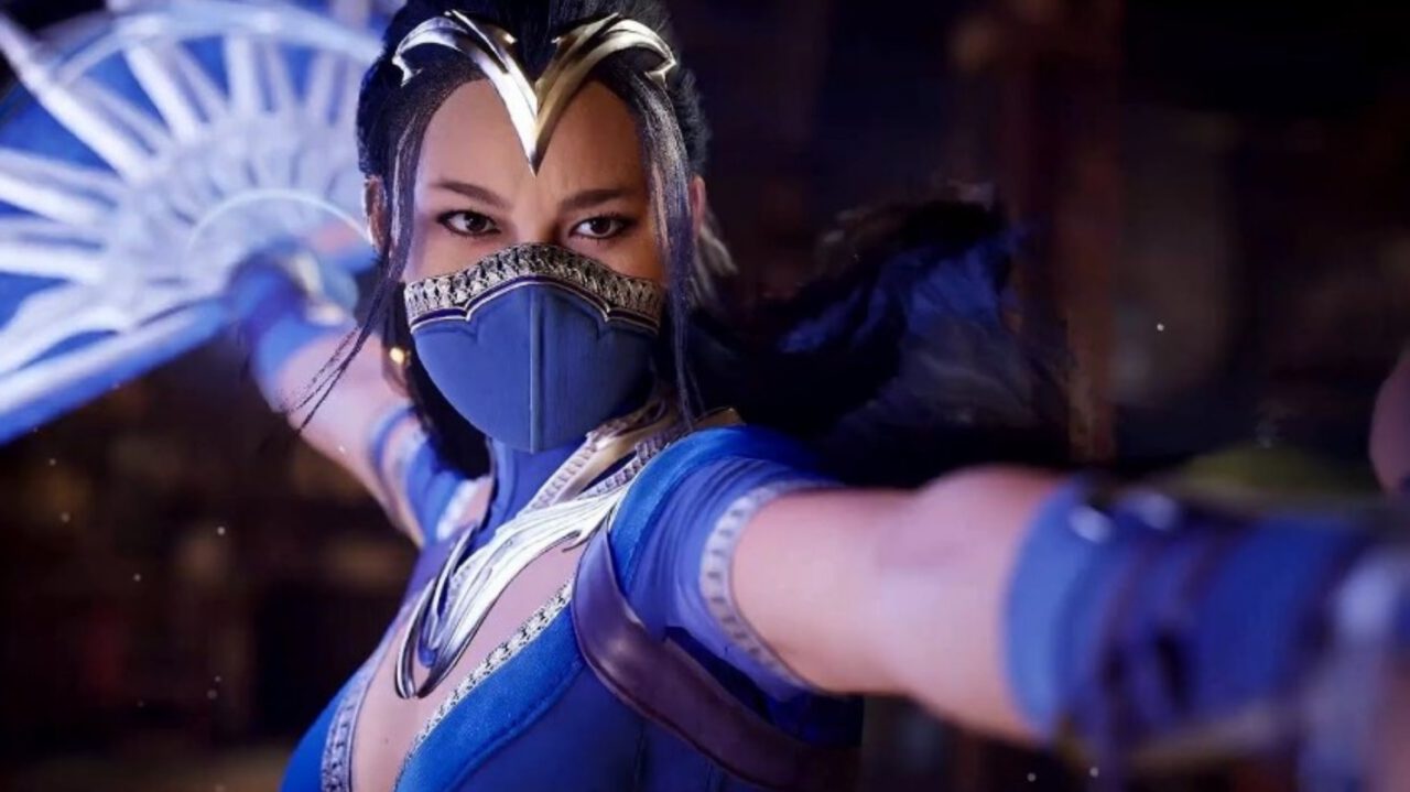 A close up of Kitana from Mortal Kombat in blue as she charges up her infamous fan attack.