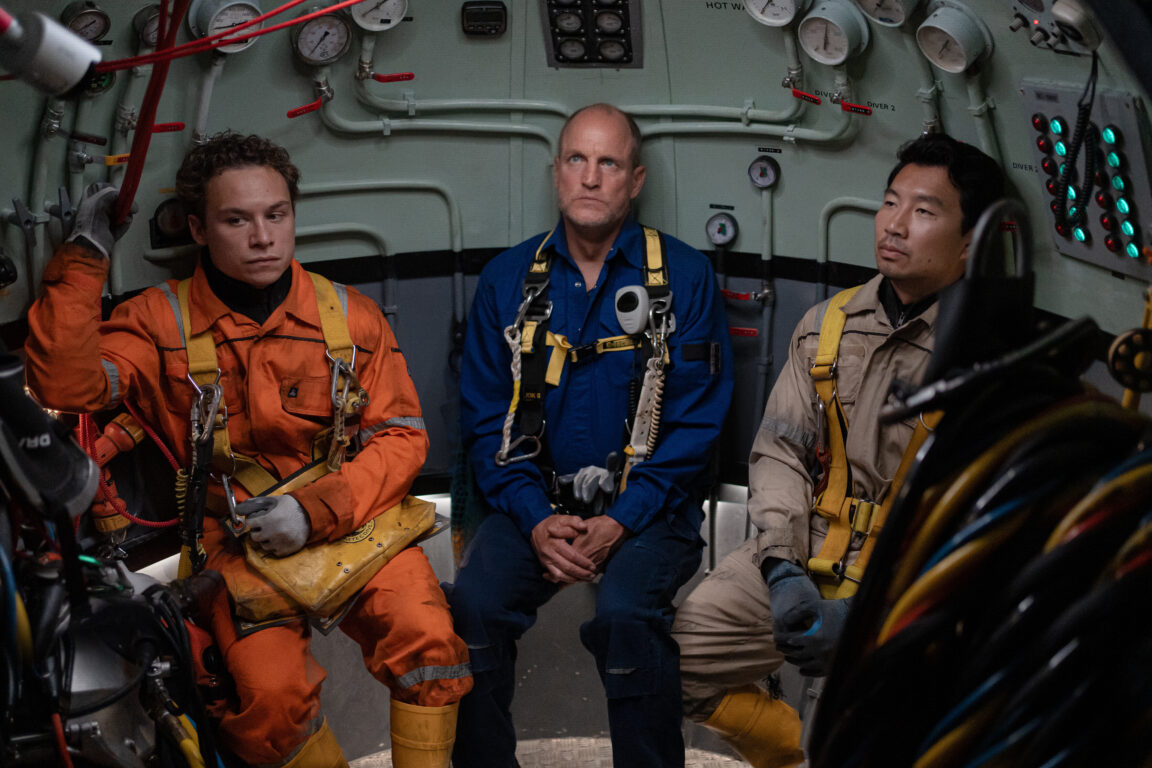 Divers Chris (Finn Cole), Duncan (Woody Harrelson) and Dave (Simu Liu) wait to enter the water in Last Breath