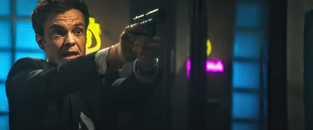 Nate (Jack Quaid) pulls a gun on tattoo artist Zeno in Novocaine