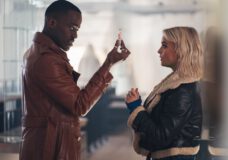 The Doctor, a Black man, shows Ruby Sunday, a white woman, a vial containing an unknown liquid while standing in a brightly lit room on Doctor Who Season 2 Episode 4, "Lucky Day."