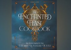 The cover of Enchanted Feast Cookbook, which is blue with a golden crest that shows two dragons.