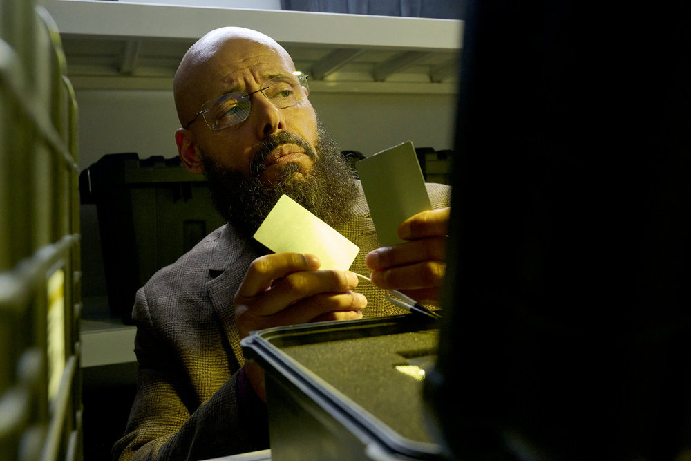 Auggie searches through the archives at ASDRA. He holds a special weapon on SurrealEstate Season 3 Episode 2, "Night Terrors."