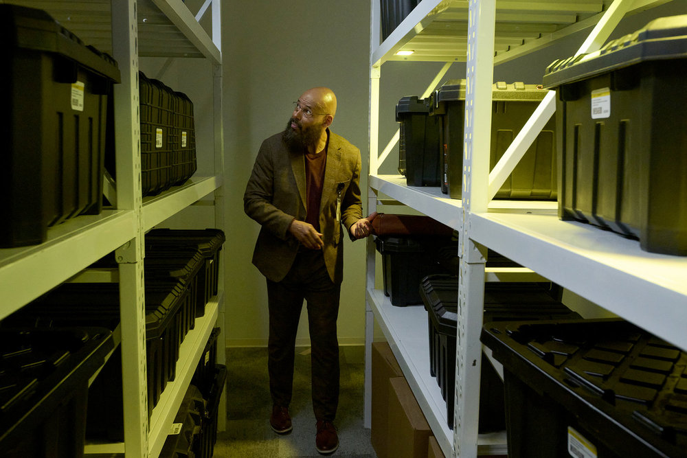 Auggie walks through rows of special weaponry at ASDRA on SurrealEstate Season 3 Episode 2, "Night Terrors."