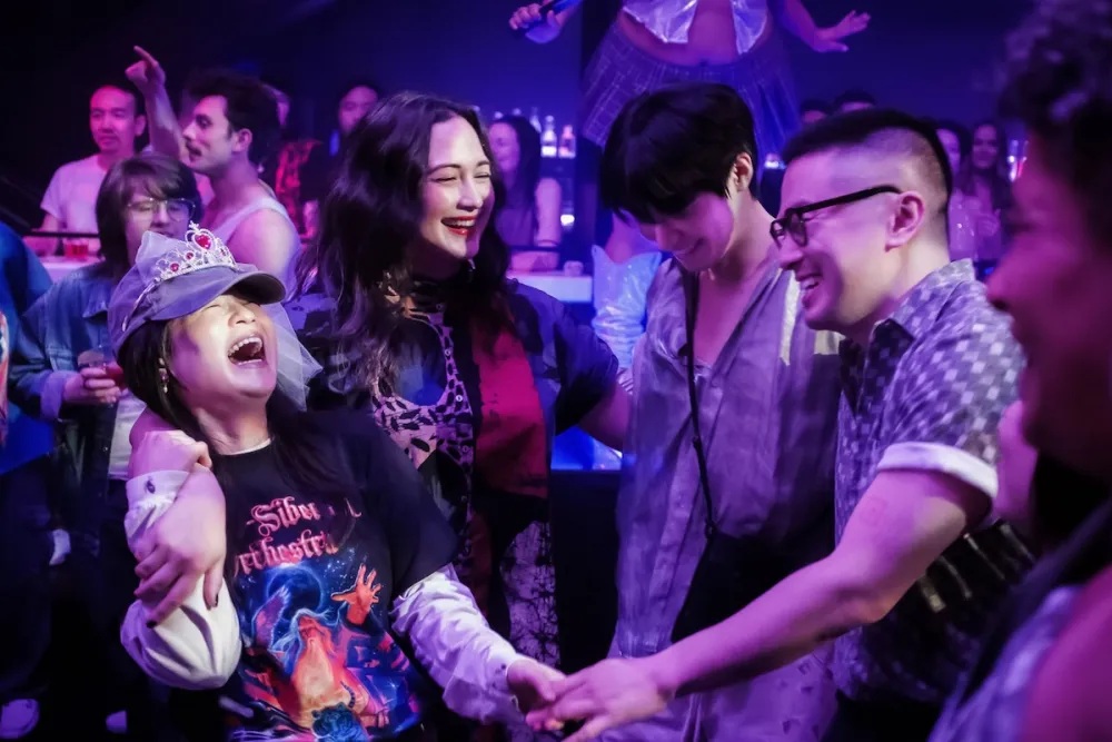 Angela, Lee, Min and Chris all laugh while on the dancefloor in the movie The Wedding Banquet.