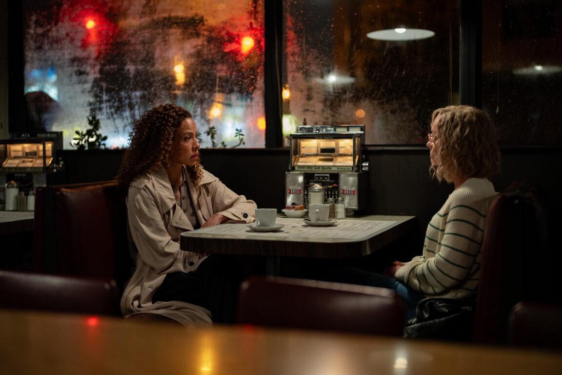 Taissa and Misty sit in a booth across from each other in a restaurant during the evening on Yellowjackets Season 3 Episode 10, "Full Circle."