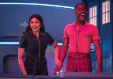 Belinda and the Doctor hold hands while standing outside the TARDIS and grinning on Doctor Who Season 2 Episode 6, "The Interstellar Song Contest."