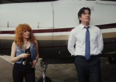 Charlie and Danny lean against the side of a private plane while chatting on Poker Face Season 2 Episode 3, "Whack-a-Mole."