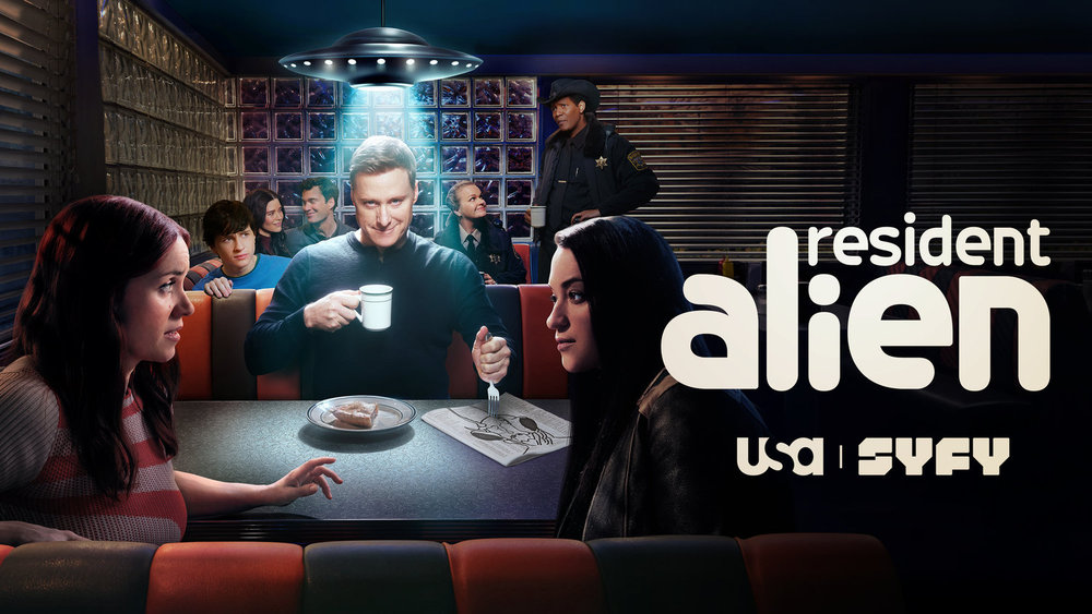 The key art for Resident Alien Season 4 shows Harry Vanderspeigle looking menacing while sitting in a dimly lit diner. He's stabbing his fork through a crude drawing of an alien. The other characters sit in the surrounding booths while chatting.