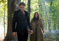 Luke and Susan stand in the woods during the day while looking down at something on the ground on SurrealEstate Season 3 Episode 5, "The Gardener."