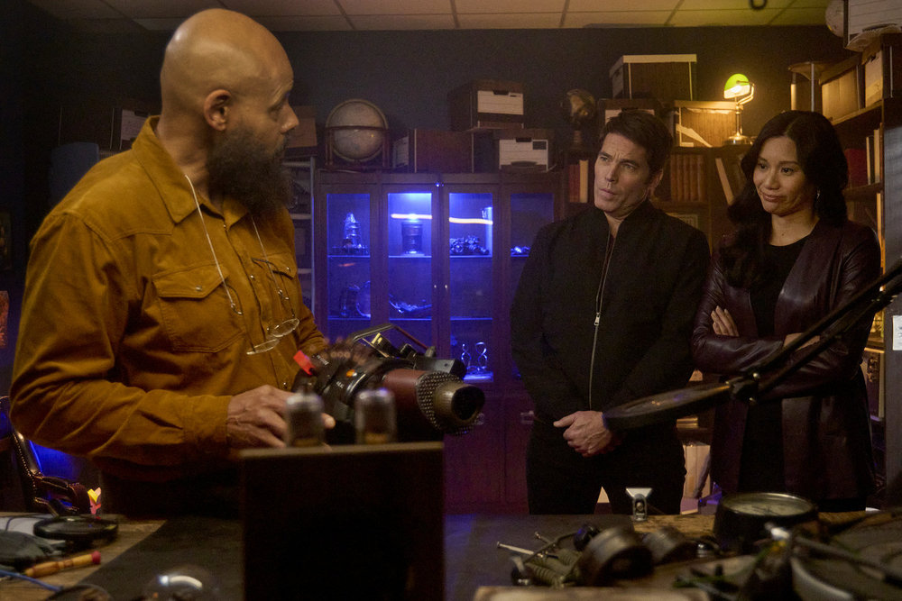 August, Luke and Lomax stand in August's office while the latter fiddles with a new device on SurrealEstate Season 3 Episode 7, "A Slice of Afterlife."